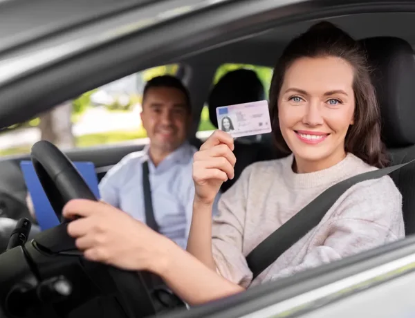 Couple in car women holding fake id card maker